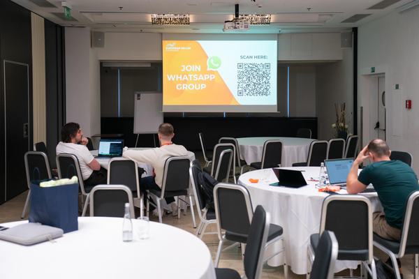 EUSECON 2026 breakout room with round tables and a screen at the Grandior Hotel Prague