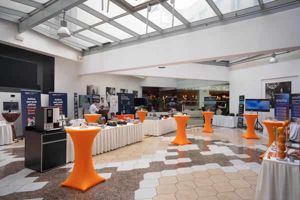 Sponsor stands and standing tables in the EUSECON 2026 expo area at the Grandior Hotel Prague